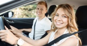 young couple in their car